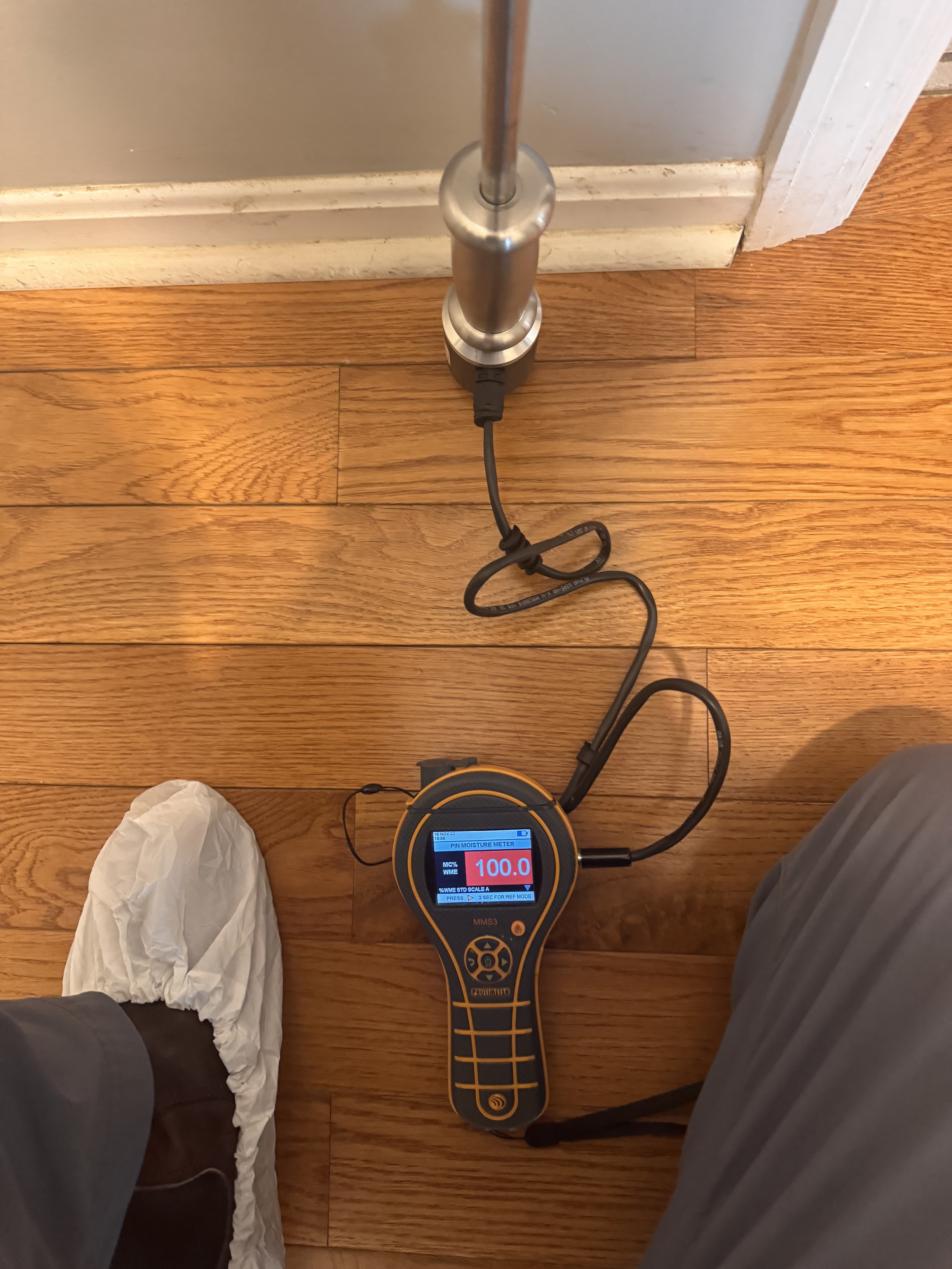IRS technician using moisture meter to map water damage in a Ozark home