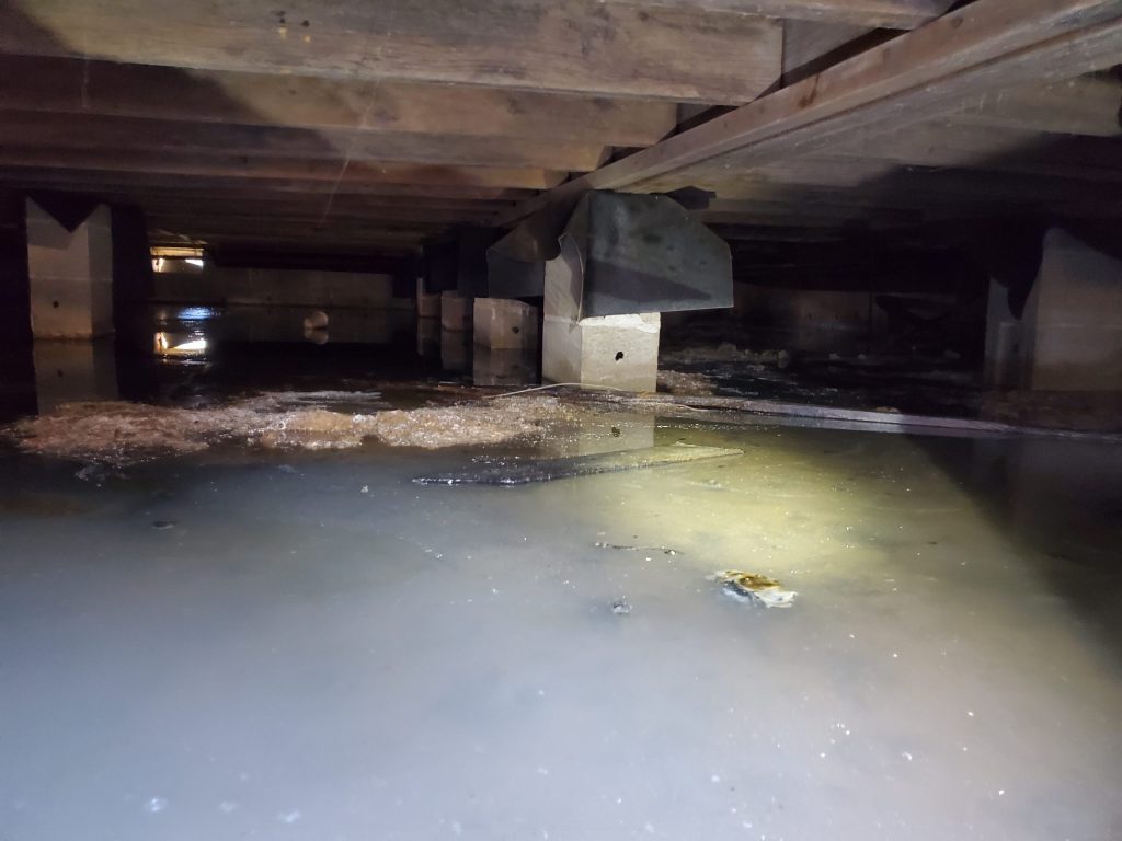 Standing water in a flooded crawl space after a Ozark storm