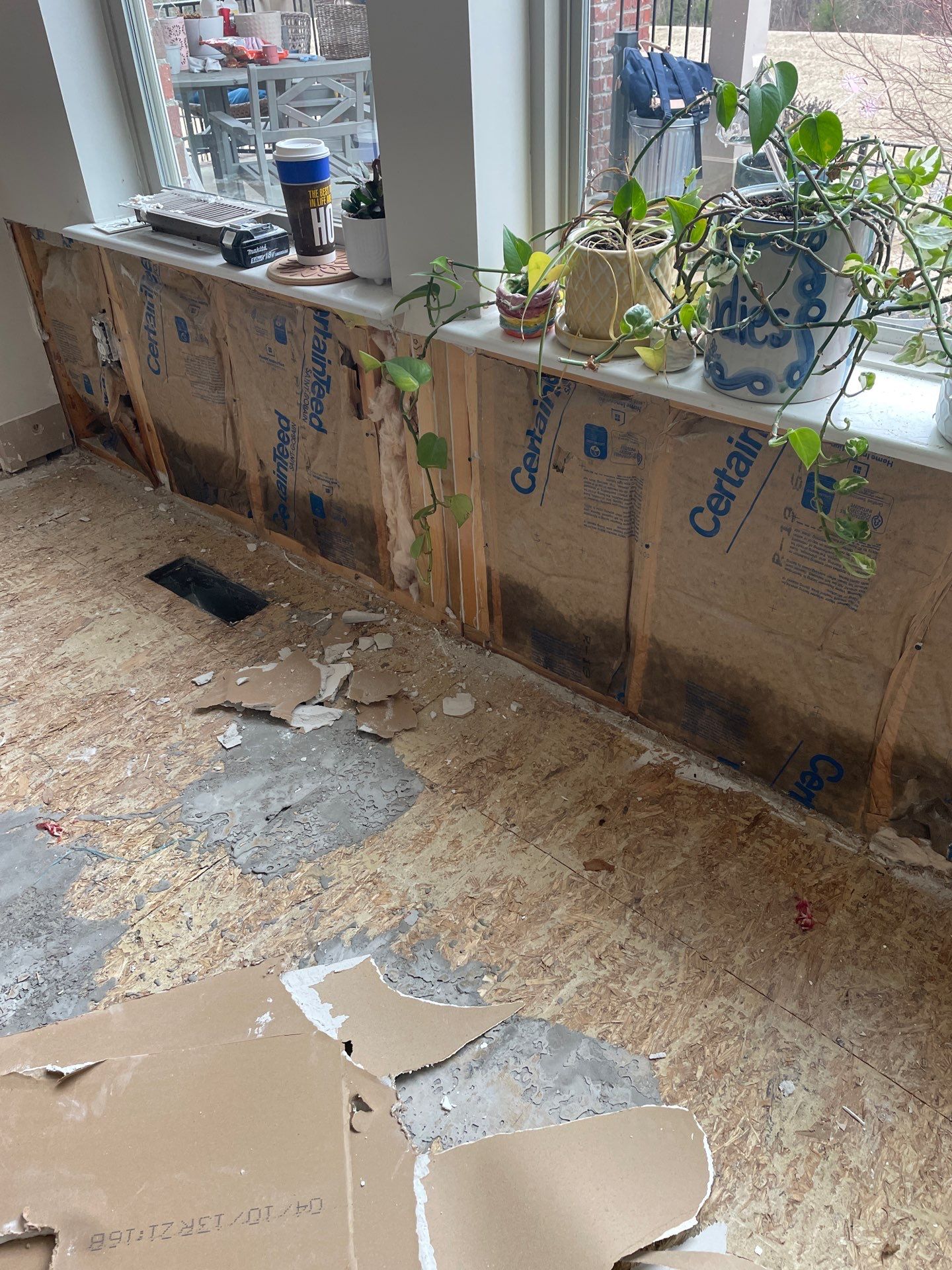 Damaged wall insulation and subfloor after storm damage in Ozark