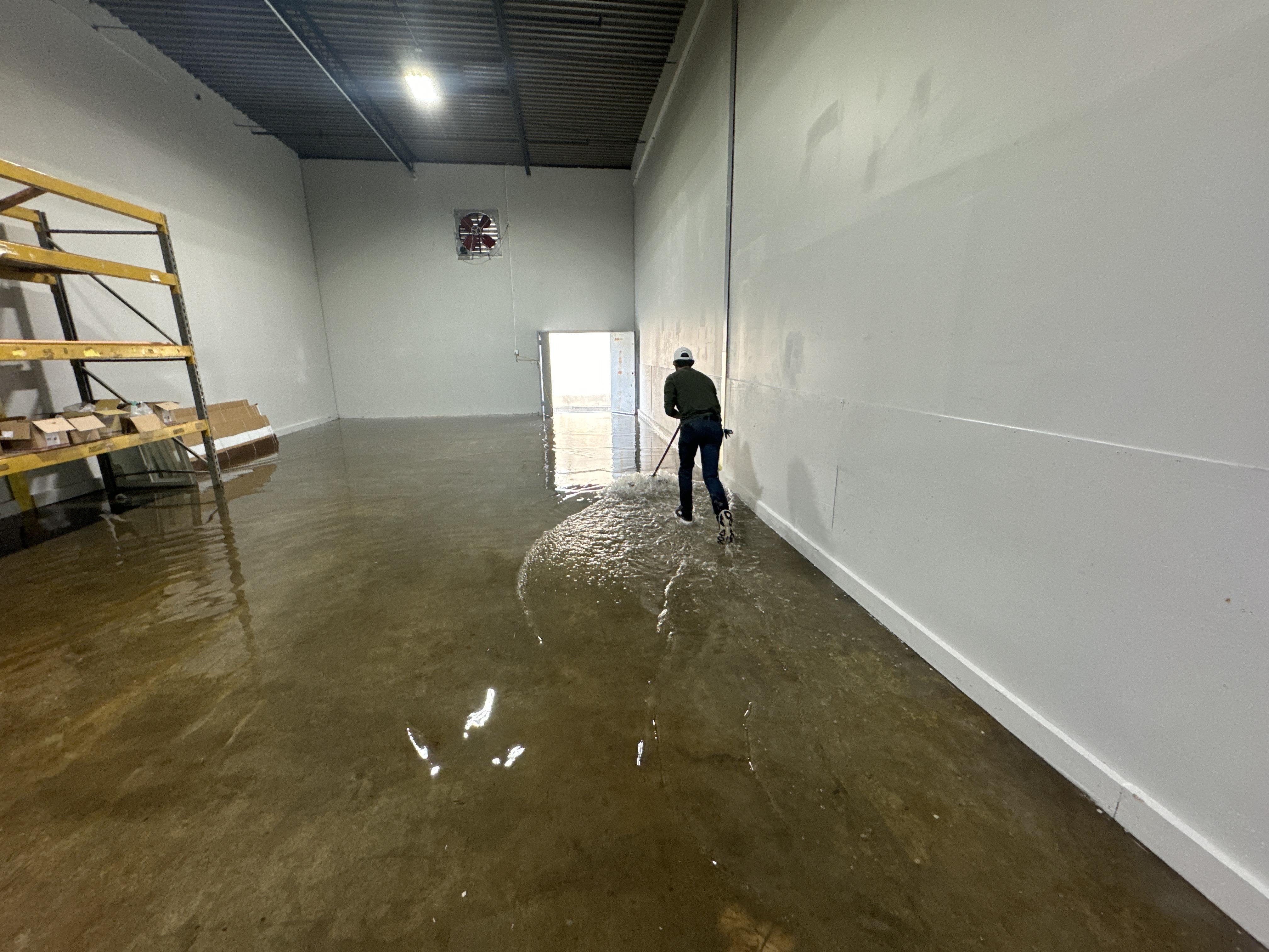 IRS crew member extracting standing water from a Ozark commercial building