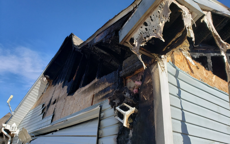 Exterior of a Ozark house with fire damage to roof and siding